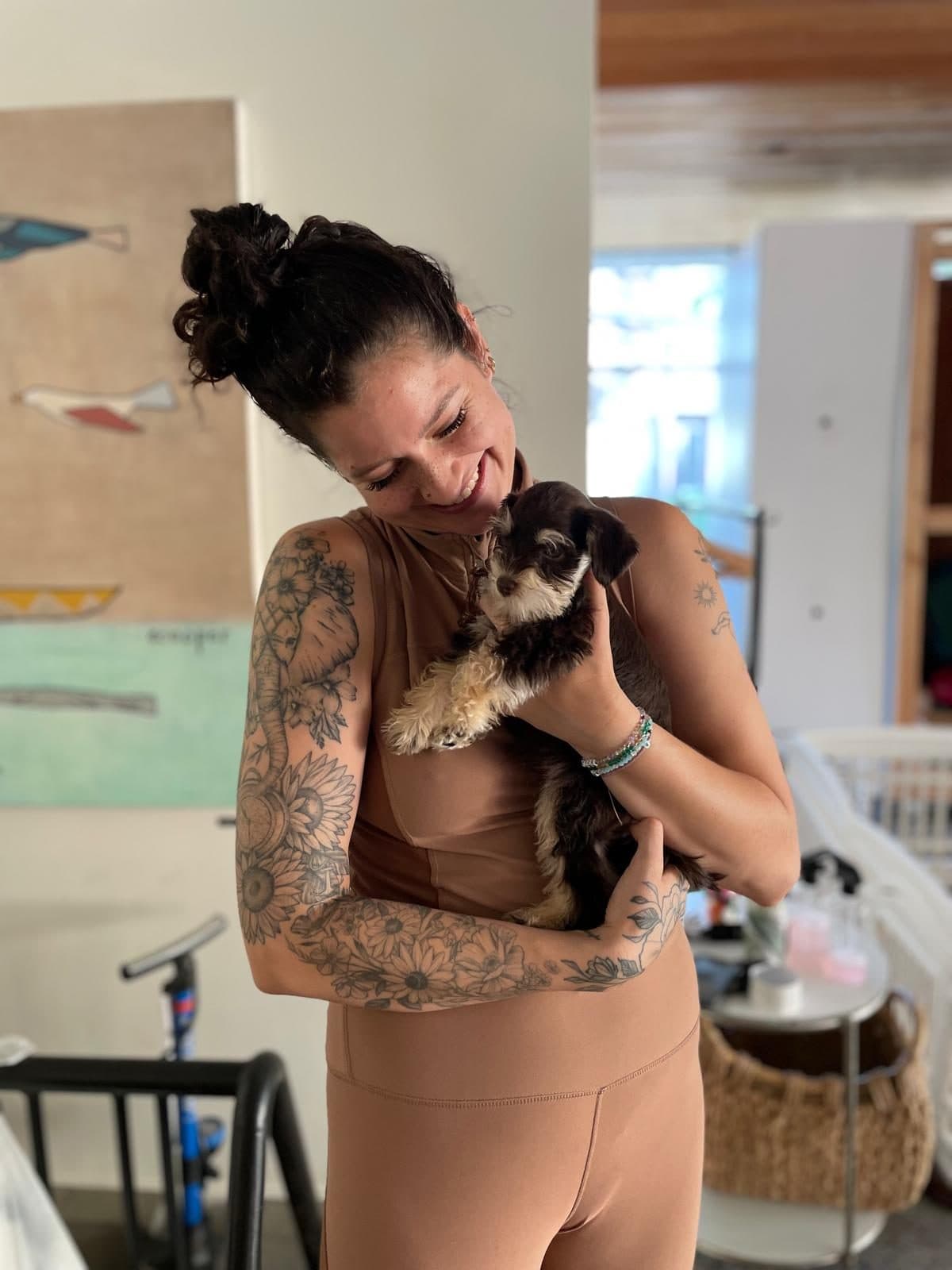 A woman holding a Schnauzer puppy at the studio in Langley